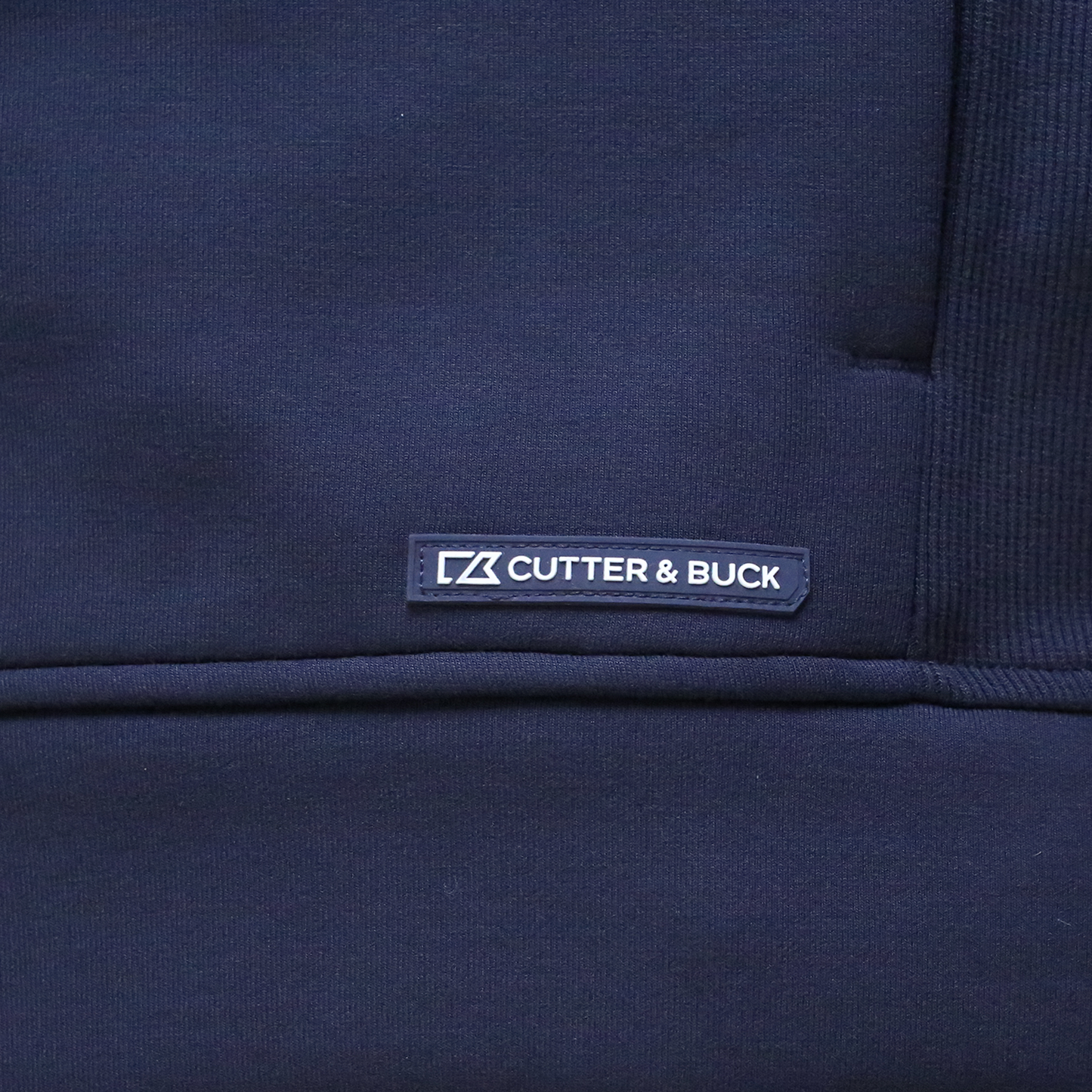 Close up of Cutter and Buck logo on bottom left.