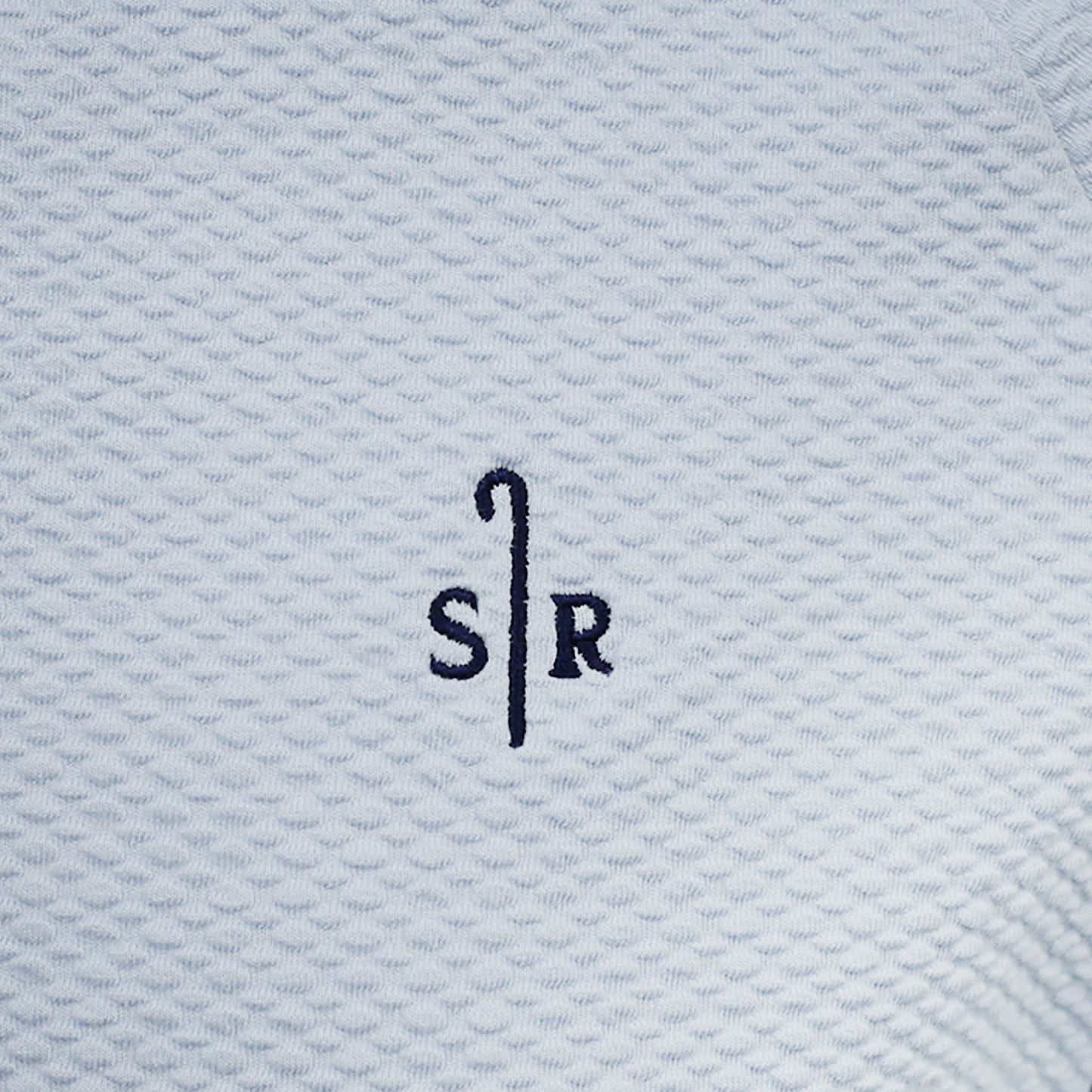 Close up of light blue textured fabric with Sheep Ranch logo