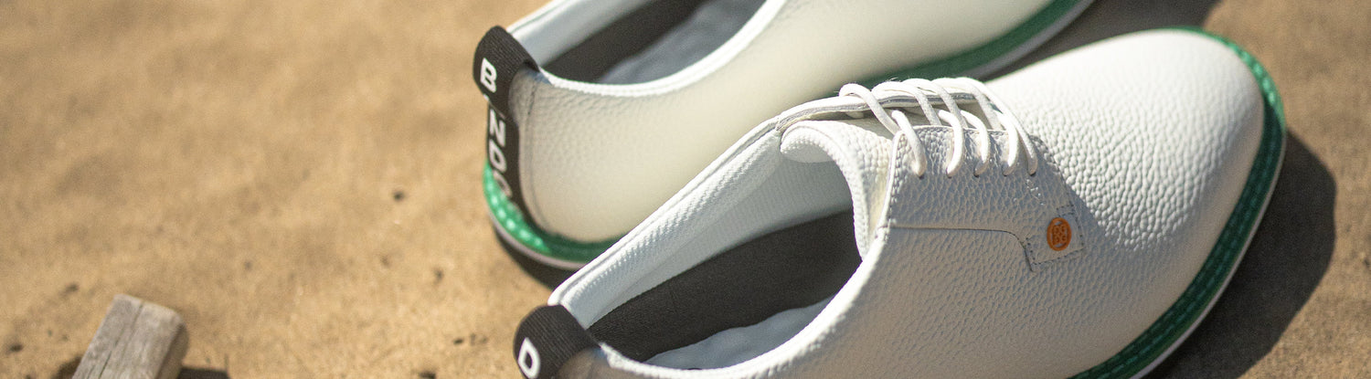 Bandon Dunes custom shoe. Shoe is white, with green, black and orange. 