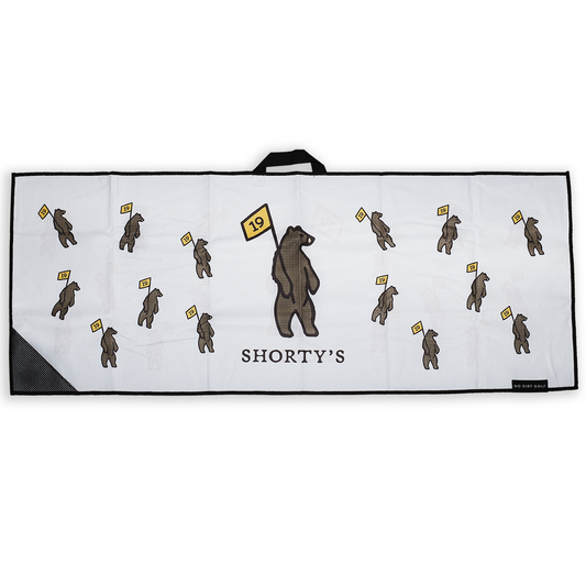 White golf towel with Shorty's bear logo. Has a hang loop and scrubber corner. 