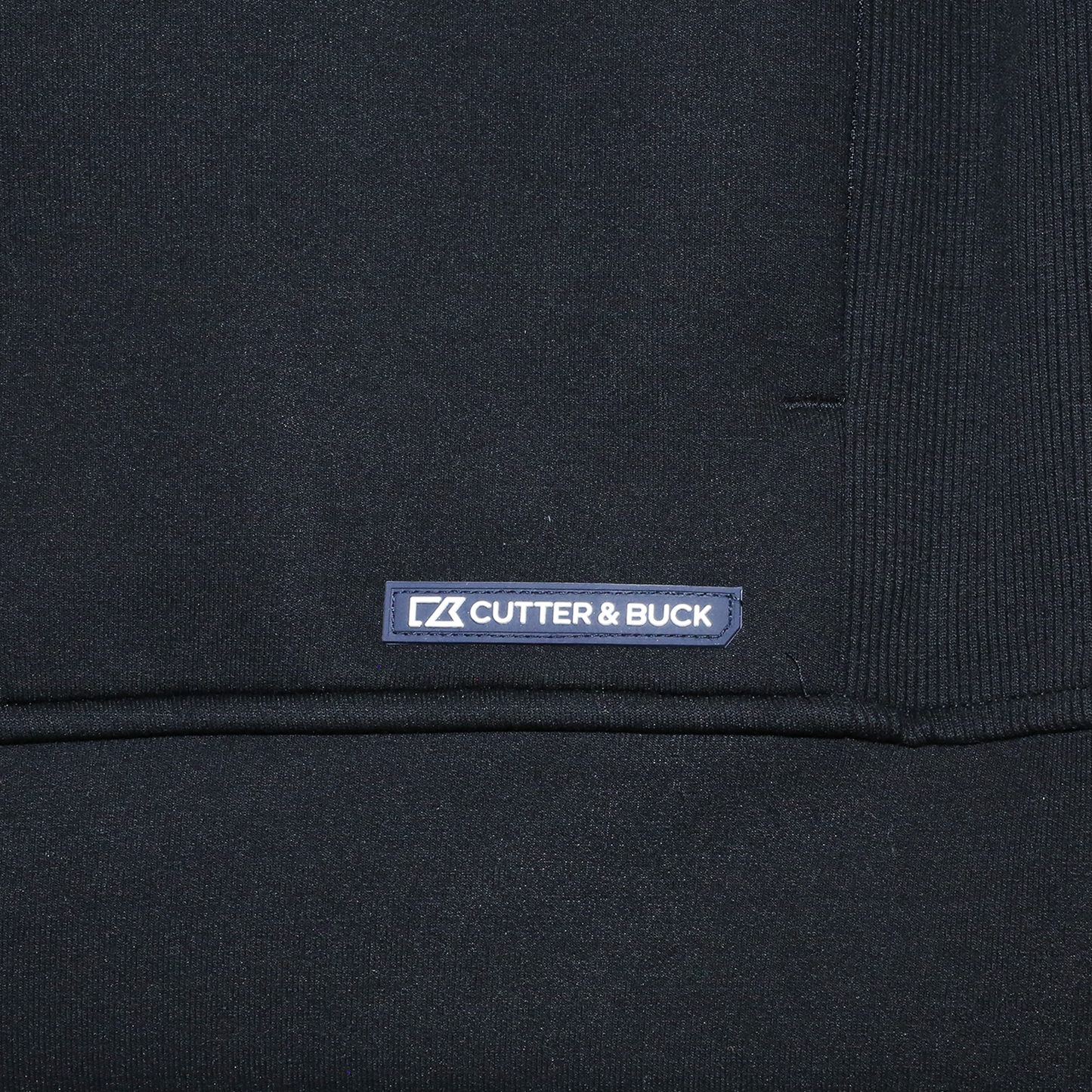 Close up of Cutter and Buck logo on bottom left.