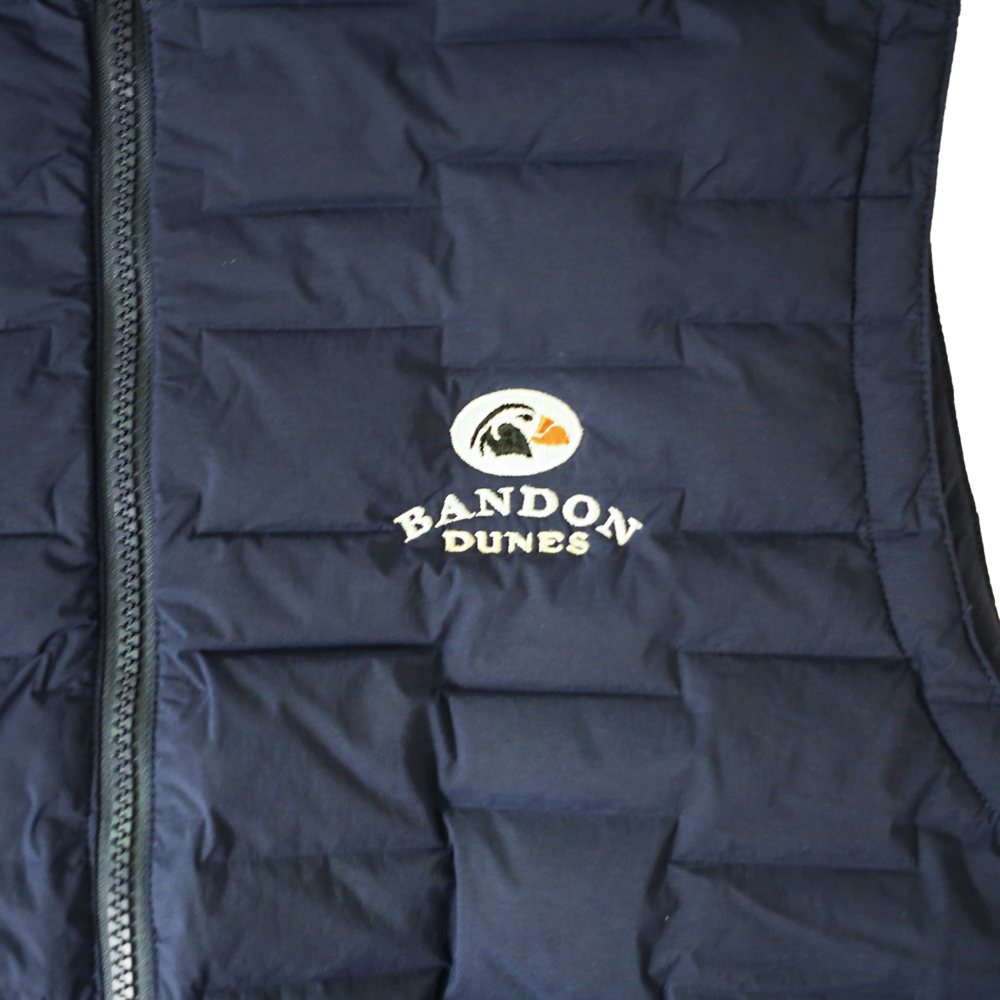 Close up of embroidered Bandon Dunes logo and quilted fabric.
