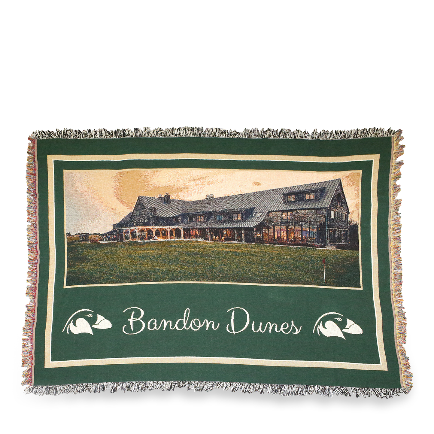 Woven green blanket with Bandon Dunes Lodge picture and puffin logo.