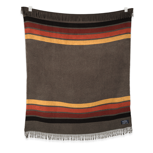 Brown blanket with brown, red, orange, and gold fall color stripes. Has Bandon Dunes patch.