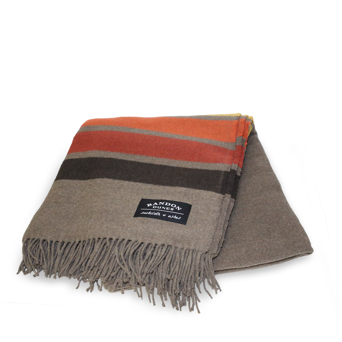 Brown blanket with dark brown, red, orange, and gold fall color stripes at top and bottom. Shows fringe and Bandon Dunes patch.