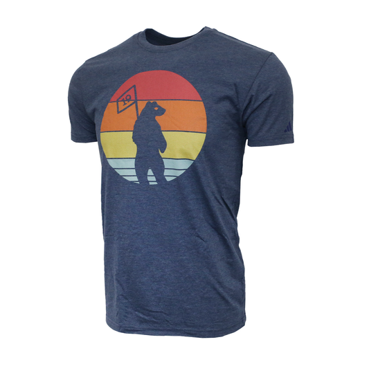 A navy Adidas crew-neck t-shirt featuring a large circular graphic on the center chest. The graphic depicts a Shorty's logo silhouetted in sunset composed of horizontal bands in red, orange, yellow, and light blue.